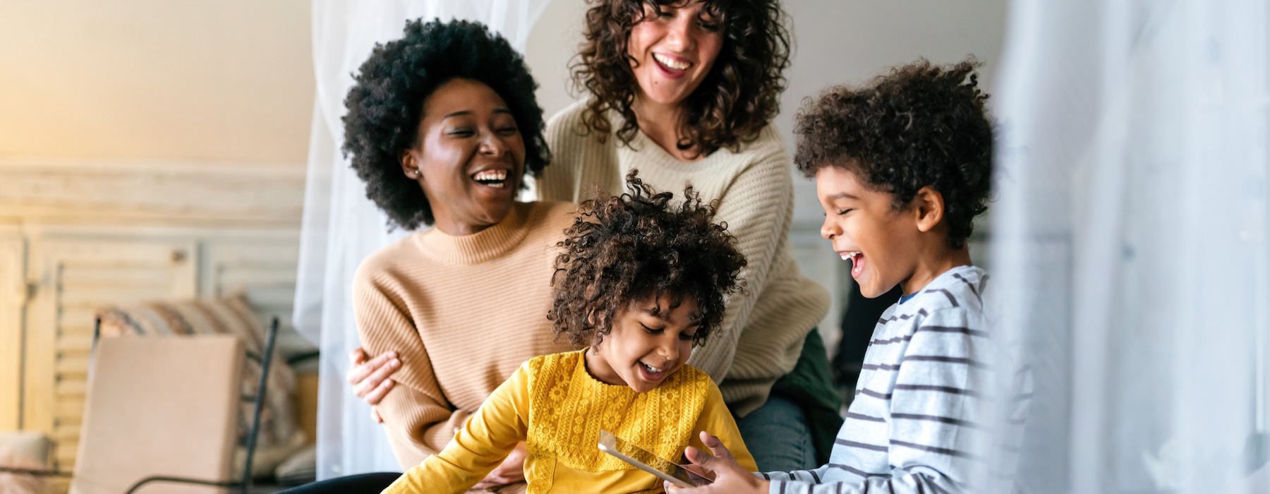 a family sitting on a bed