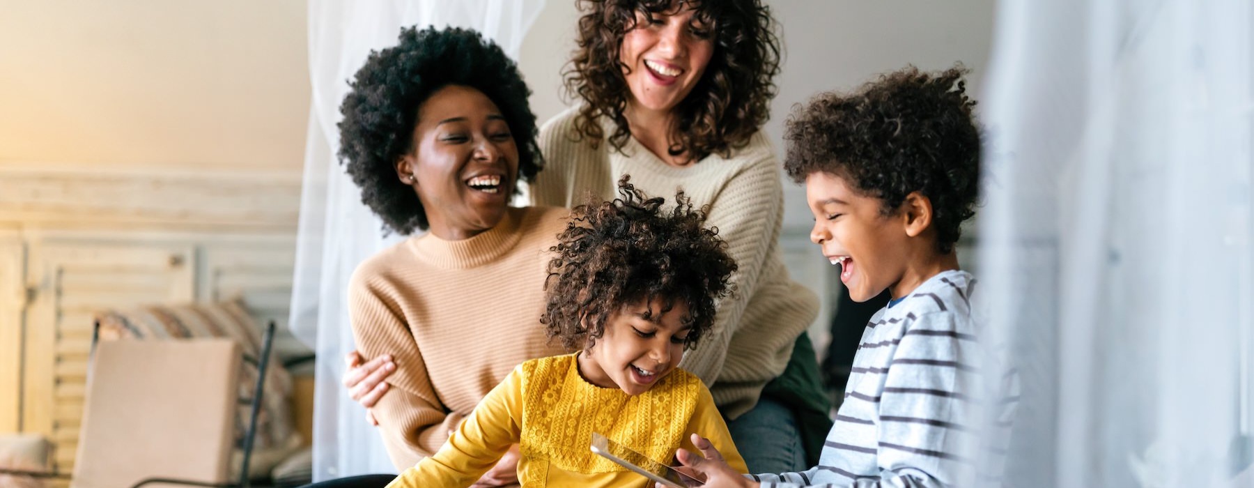 a family sitting on a bed