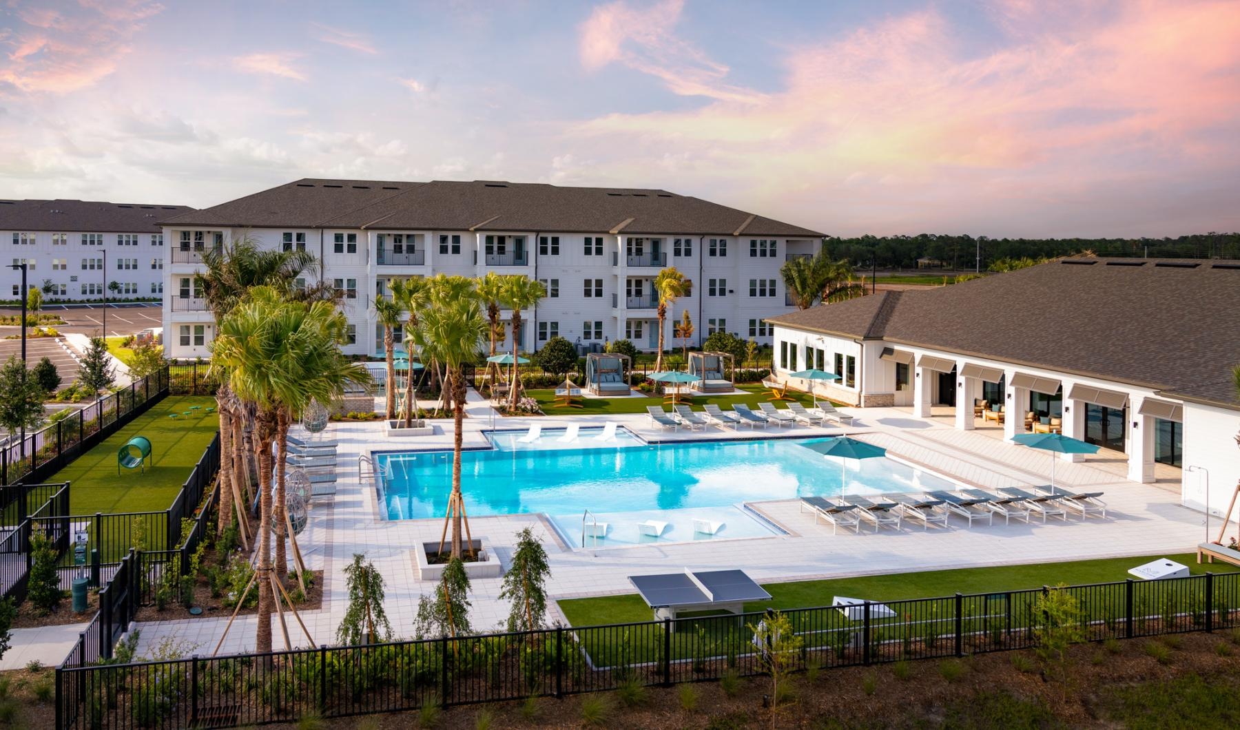 a large building with a pool in front of it